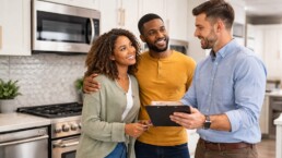 Multicultural family shopping for modern kitchen appliances in a bright showroom with a friendly sales associate assisting