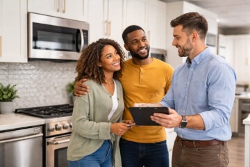 Multicultural family shopping for modern kitchen appliances in a bright showroom with a friendly sales associate assisting